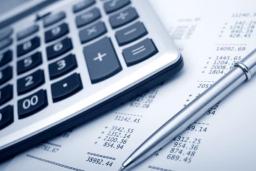 A calculator on top of a ledger sheet